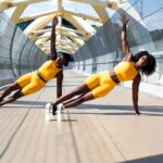 woman in yellow sports bra and yellow shorts jumping on white metal frame
